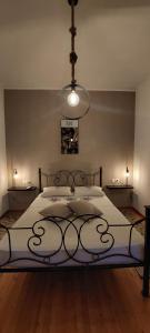 a bedroom with a large bed with a chandelier at Buenavista apartment in Ýpsos