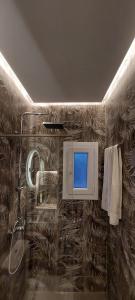 a bathroom with a shower and a blue screen at Buenavista apartment in Ýpsos