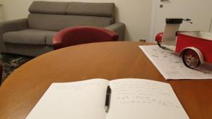 an open book on a wooden table with a chair at A Casa di Luca in Faenza +8 photos