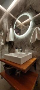 a bathroom with a white sink and a mirror at Buenavista apartment in Ipsos