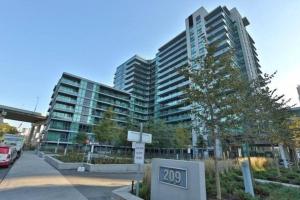 a parking lot in front of a large building at Lake View Apartment w/Parking! in Toronto