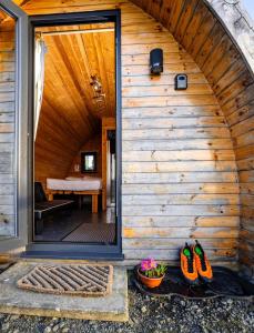 a wooden house with a large glass door at The Arns Glamping Pods in Bridge of Allan