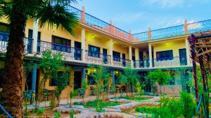 an exterior view of a hotel with a courtyard at HOTEL RESTAURANT LA KaSBAH in Tinerhir +53 photos