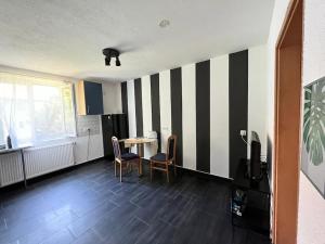 a living room with a table and chairs in a room at Jennis Bi-Bi 2 bedrooms Apartment in Bietigheim-Bissingen