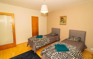a room with two beds in a room at 2-Bedroom Apartment in Heart of City Center in Turku