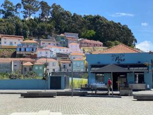 a person standing in front of a building in front of a city at Cosy House in Porto Marina in Vila Nova de Gaia