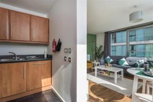 two views of a kitchen and a living room at Luxury Milton Keynes Apartment at The Prevé in Milton Keynes