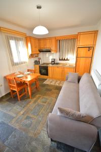 a living room with a couch and a table at Pergola Apartment I in Lagoúdi Zía
