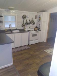 a kitchen with white cabinets and a white stove top oven at Mi-o My Getaway in Mio