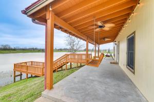 a covered porch of a house with a ceiling fan at Angleton Vacation Rental with On-Site Lake Access! in Angleton