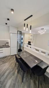 a kitchen and dining room with a table and chairs at AIRPORT 24&24 CAR PARKING in Chişinău