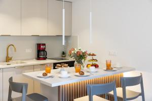 a kitchen with a table with food on it at Floret Apartment in Cavtat