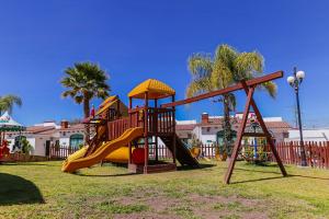 a playground with a slide in a park at Hotel Real de San Jose in Tequisquiapan