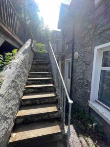 a set of stairs leading up to a building at Carronvale. 3 Bedroom Oban Apartment. in Oban