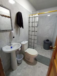 a bathroom with a sink and a toilet and a shower at Apartamento Esmeralda Arboletes in Arboletes