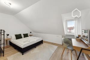 a white bedroom with a bed and a desk at Day Young Life/ DYL Hosting 55 qm in Nürnberg