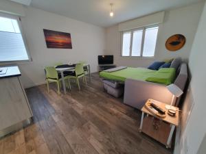 a bedroom with a bed and a table and a kitchen at MYHOUSE APARTMENT in Cervignano del Friuli