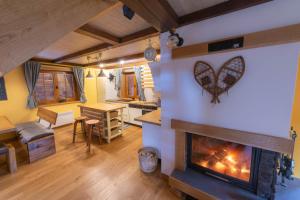 a living room with a fireplace with a heart on the wall at Vila Olimp in Jasenak
