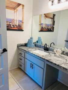 a bathroom with a sink and a mirror at The House of Serenity: Close to Fort Sill & Casino in Lawton