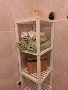a white towel rack in a bathroom with towels at Mi'Ele Apartments in Pergine Valsugana +24 photos