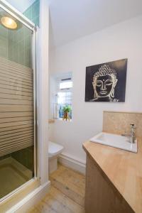 a bathroom with a shower and a sink and a toilet at Deluxe 1 Bed Versace Hot Tub Sky TV Cinema Screen in Great Sampford +28 photos