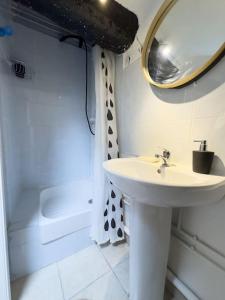 a bathroom with a sink and a mirror and a toilet at Studio - vieux port in Marseille