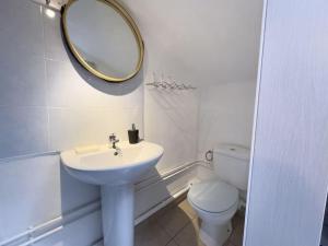 a bathroom with a sink and a toilet and a mirror at Studio - vieux port in Marseille