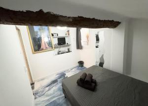 a bedroom with a bed with a pair of shoes on it at Studio - vieux port in Marseille