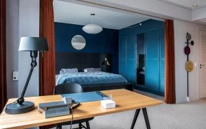 a room with a bed and a table with a desk sidx sidx sidx at Hotel Jutlandia in Frederikshavn +10 photos