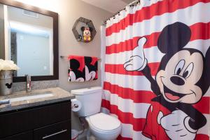 a bathroom with a red and white shower curtain at Loft apartments at Hollywood FREE parking close to Studios Universal in Los Angeles