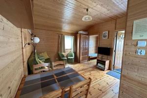 a wooden room with a table and a living room at Holiday resort, Bobolin in Bobolin