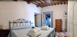 a bedroom with a bed with towels on it at Joka in Potenza Picena