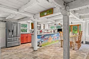 a kitchen with a refrigerator and a table at Summer Rental Magical Converted Barn & Pool House in Pleasant Valley