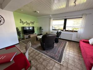 a living room with a red couch and a tv at Apartment58 in Wiehl