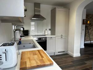 a kitchen with a sink and a counter top at Sterling Stylish 2 bedroom Central Modern Apartment in Darlington