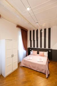 a bedroom with a bed with black and white stripes at Santa Croce Dream Suites in Florence