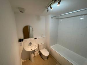 a bathroom with a sink and a toilet and a bath tub at Marco Island apartment in Nottingham