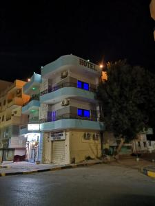a hotel building with blue lights in the night at Four Seasons Hotel in Hurghada