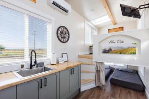 a kitchen with a sink and a clock on the wall at Una Vita in Apple Valley +31 photos