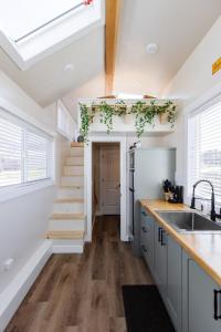 a kitchen with white cabinets and a staircase in the background at Una Vita in Apple Valley