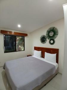 a bedroom with a large bed and a window at New Door Apartments in Nadi