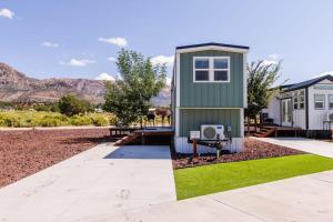 a tiny house with a yard with a bench at Harrington Tiny House in Apple Valley