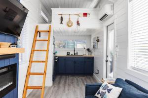 a tiny house with a ladder and a kitchen at Zion Stay, Scenic Tiny Home & Sunset Views in Apple Valley