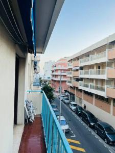 a balcony of a building with cars parked on a street at Studio 4 couchages à 200 m de la plage + garage in Juan-les-Pins