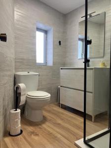 a bathroom with a toilet and a sink and a shower at Casa Sina in Riópar +6 photos