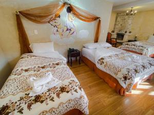 Postel nebo postele na pokoji v ubytování Golden Rest Latacunga
