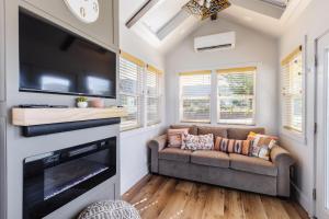 a living room with a couch and a flat screen tv at Sun Catcher in Apple Valley
