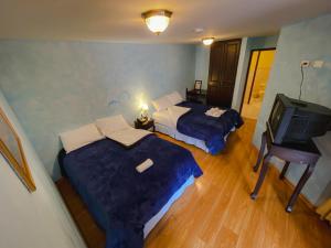 Postel nebo postele na pokoji v ubytování Golden Rest Latacunga