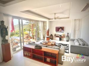 a living room with a couch and a table at Luxury Asian Flair Villa in Ko Phangan