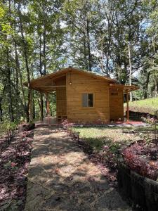 uma pequena cabana de madeira no meio de uma floresta em Hotel en Finca Chijul, reserva natural privada em San Juan Chamelco